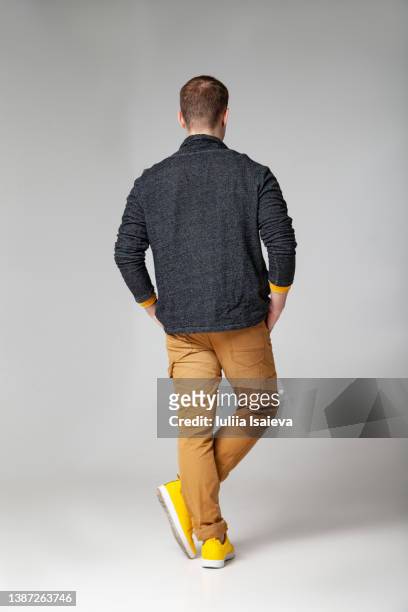 unrecognizable stylish man standing in studio - rear view stock pictures, royalty-free photos & images