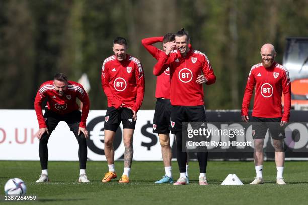 Chris Gunter, Aaron Ramsey, Gareth Bale and Jonny Williams of Wales react during a Wales Training Session at Vale Resort on March 23, 2022 in...