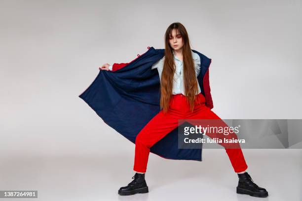 young woman in outerwear spinning around - woman full body isolated stock pictures, royalty-free photos & images