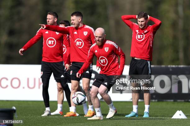 Jonny Williams of Wales in action as teammates Chris Gunter, Aaron Ramsey and Ben Davies react during a Wales Training Session at Vale Resort on...