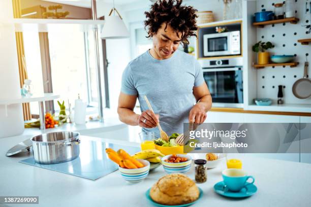 he is in his element when cooking - afro man stock pictures, royalty-free photos & images