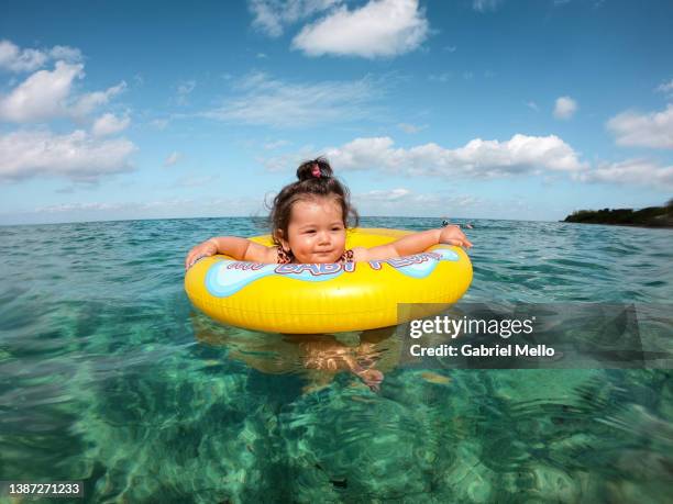 baby floating in crystal clear waters at palancar beach - beautiful beach babes stock pictures, royalty-free photos & images