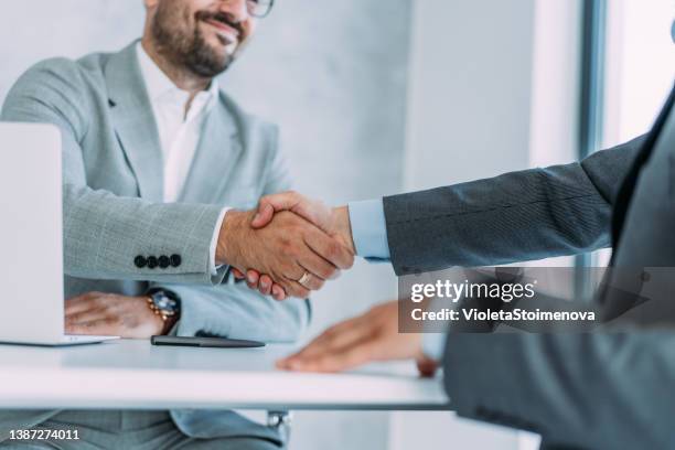 successful partnership - two men shaking hands close up stock pictures, royalty-free photos & images