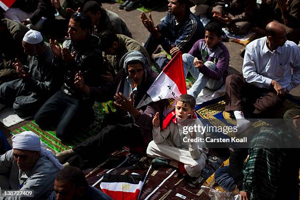 Boy attends friday prayers at Tharir Square on February 10, 2012 in Cairo, Egypt. Egyptian people await the upcoming first anniversary of the...