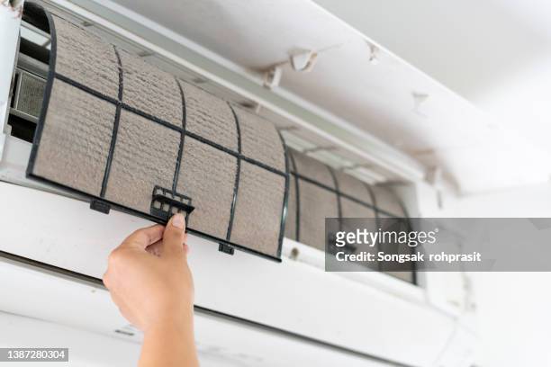 cleaning the air conditioner filter - air conditioning stock-fotos und bilder
