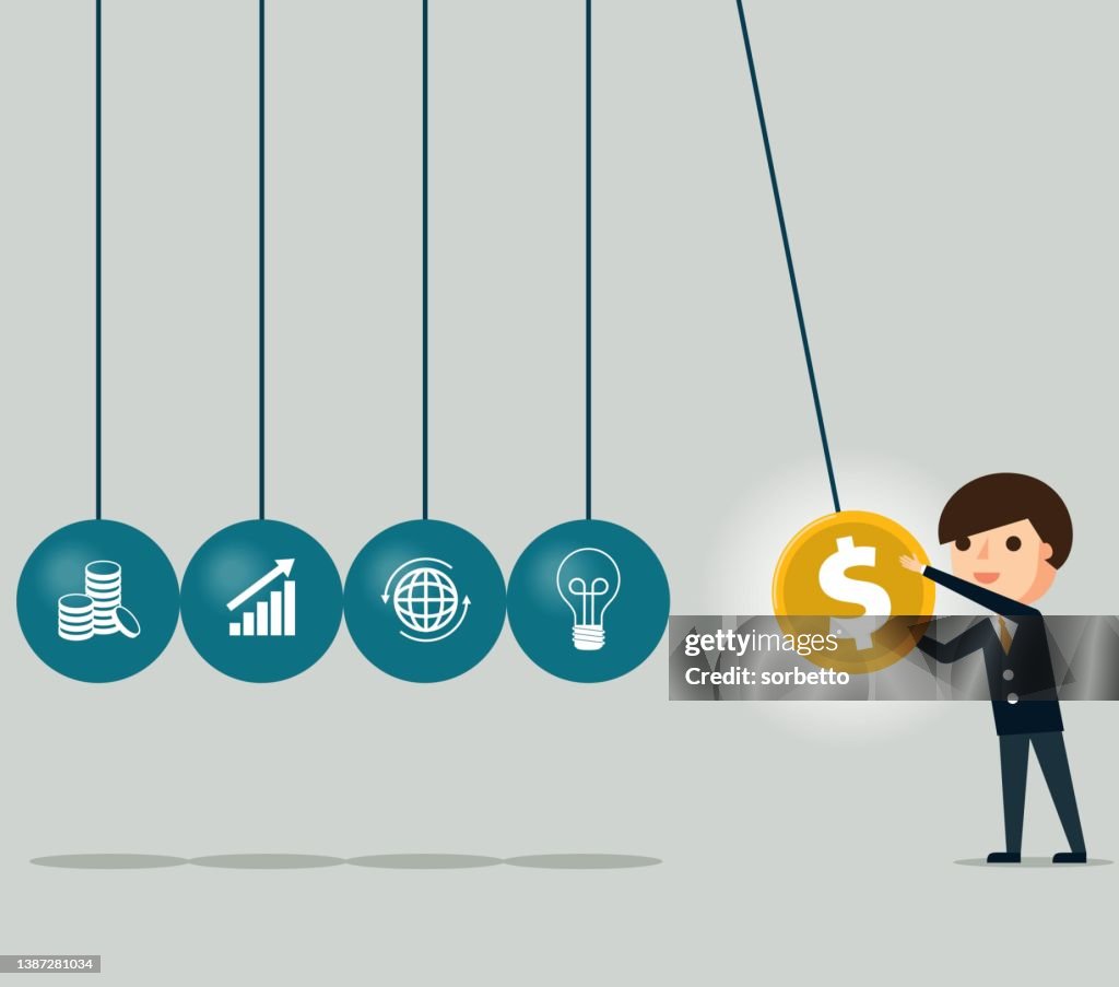 Businessman holding a swinging ball