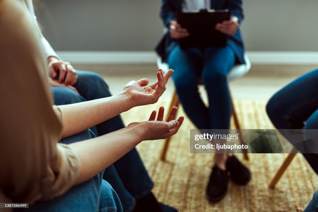 People Attending Support Group Meeting For Mental Health Or Dependency Issues In Community Space