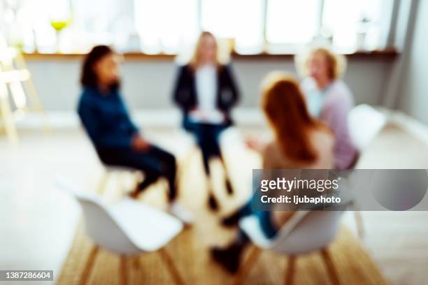 people participate in support group session - abstract defocused stock pictures, royalty-free photos & images