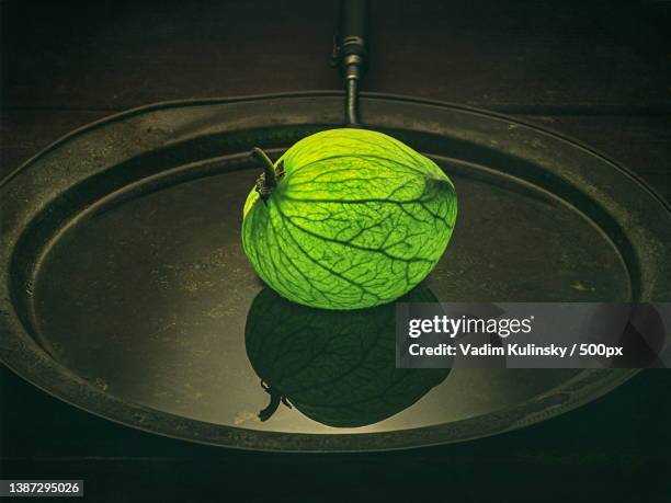 close-up of sodom apple on a platter,israel - sodom apple stock-fotos und bilder