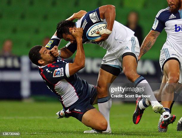 Isaia Toeava of the Blues is tackled by Mark Gerrard of the Rebels during the Super Rugby trial match between the Melbourne Rebels and the Auckland...