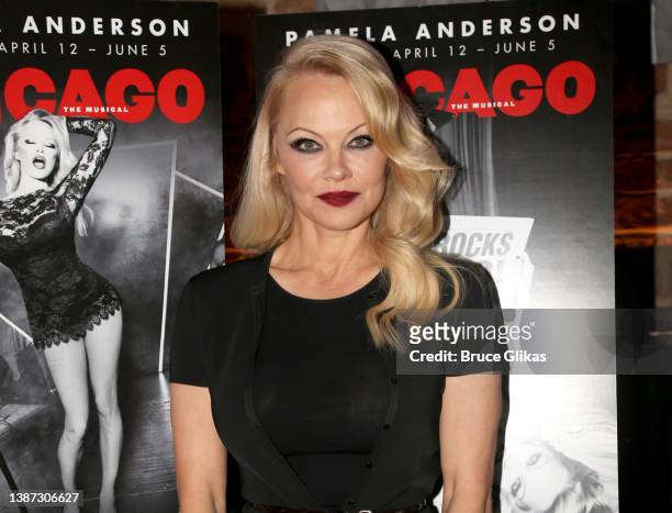 Pamela Anderson poses at a photo call for her broadway debut as "Roxie Hart" in the hit musical "Chicago" on Broadway at The Civilian Hotel on March...