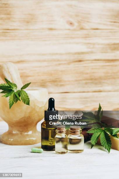 green pill, oil and jars, fresh cannabis. - cannabidiol stock pictures, royalty-free photos & images