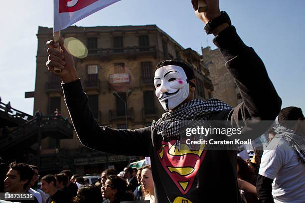 Protester wears a Guy Fawkes mask during a demonstration of students on February 11, 2012 in Cairo, Egypt. Egyptian people await the upcoming first...