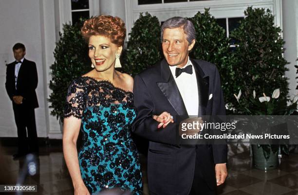 Married American couple, business executive Georgette Mosbacher and Secretary of Commerce Robert Mosbacher , arrive at the White House for the State...
