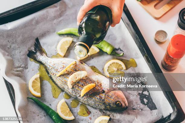 fish stuffed with herbs and lemon slices. - mediterrane kultur stock-fotos und bilder