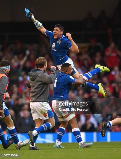 Italy centre Juan Ignacio Brex is lifted high by Toa Halafihi during the celebrations after the Six Nations Rugby match between Wales and Italy at...