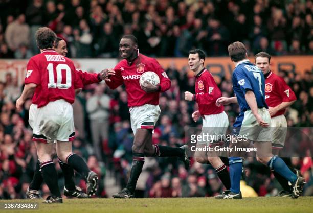 Manchester United striker Andrew Cole is congratulated by team mates after scoring the third of his five goals during the 9-0 Premier League match...
