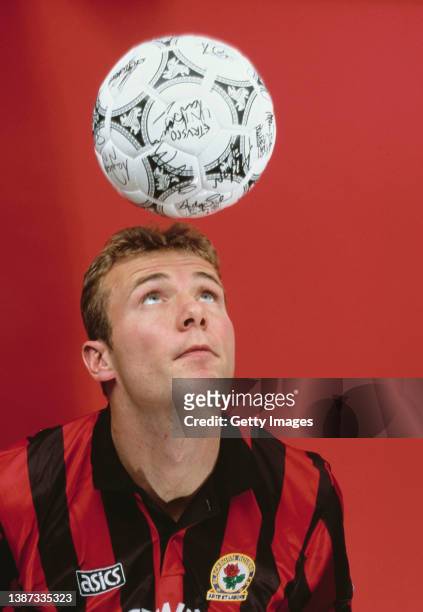 Blackburn Rovers and England striker Alan Shearer pictured heading a ball in the Rovers Red and Black away Asics kit during a studio photo shoot...