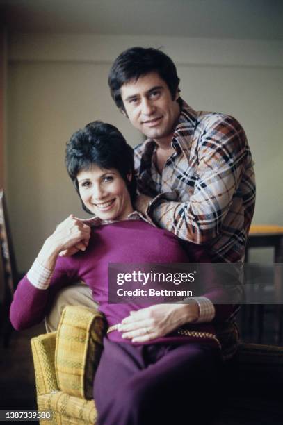 American actress and singer Michele Lee, wearing a purple sweater, and her husband, American actor James Farentino , wearing a plaid shirt and tan...