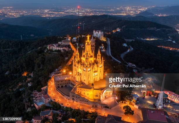 aerial view of temple sacred heart of jesus on tibidabo at dusk time in barcelona, spain. - barcellona night foto e immagini stock