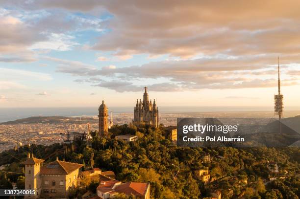 aerial view of temple sacred heart of jesus on tibidabo at sunset time in barcelona, spain. - tibidabo fotografías e imágenes de stock