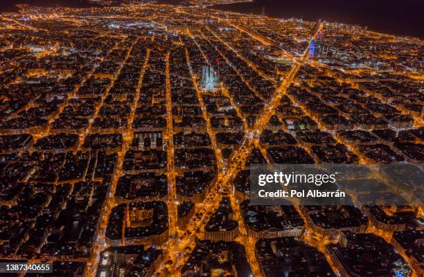 aerial night view of barcelona eixample residencial district, sagrada familia, typical urban squares, catalonia, spain. - barcellona night foto e immagini stock