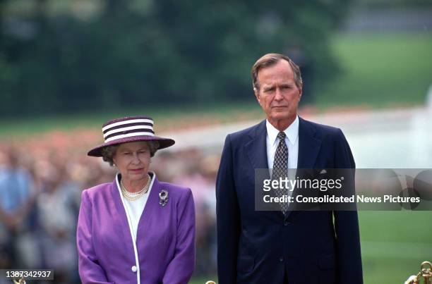 View of British monarch Queen Elizabeth II and US President George HW Bush as the former is welcomed, on the White House' South Lawn, during a State...