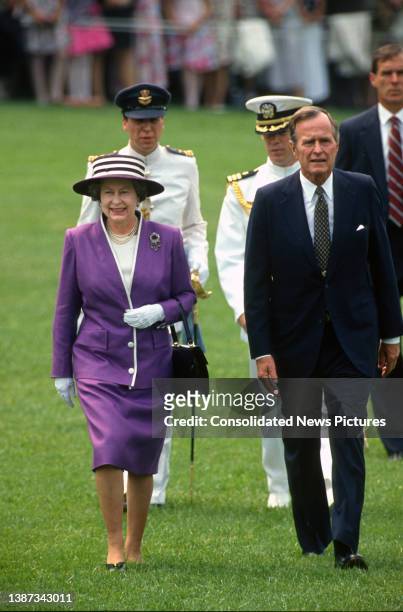 British monarch Queen Elizabeth II and US President George HW Bush walk together on the White House's South Lawn, Washington DC, May 14, 1991.