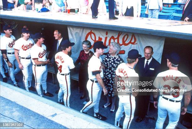 Members of the Baltimore Orioles baseball team, including Sammy Snider , Tim Hulett , and Chris Hoiles , shake hands with, rear, from left, US...