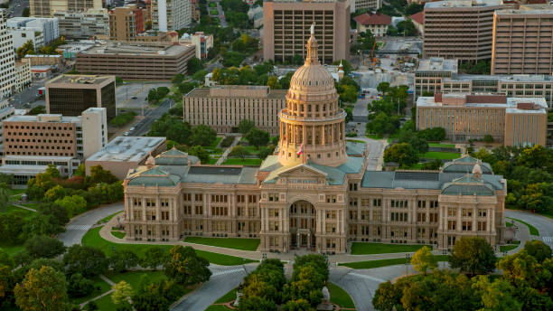 aerial building of the texas state capitol in austin at sunset - texas capitol building stock pictures, royalty-free photos & images