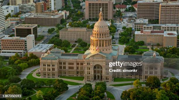 aerial building of the texas state capitol in austin at sunset - texas state capitol stock pictures, royalty-free photos & images