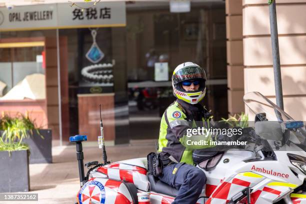 motorcycle ambulance paramedic in city street, background with copy space - australian paramedic stock pictures, royalty-free photos & images