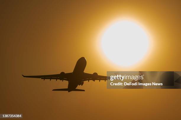 Frankfurt, Germany, : An airplane taking off in the evening sun at Airport Frankfurt on March 22, 2022 in Frankfurt, Germany.