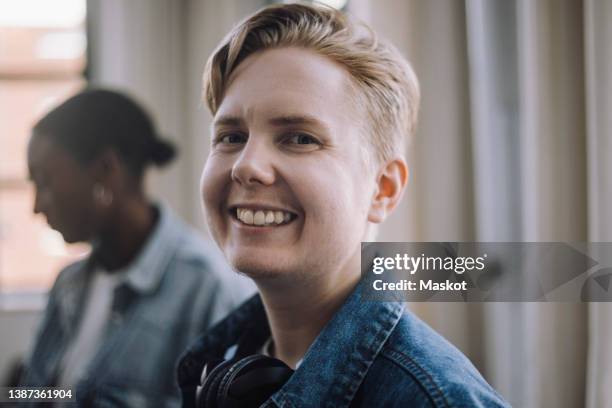 portrait of smiling male computer programmer in office - transgender fotografías e imágenes de stock