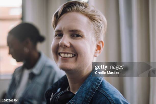 portrait of smiling male computer programmer in office - transgender bildbanksfoton och bilder