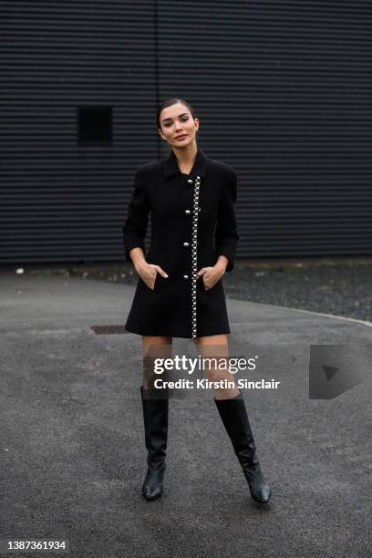 Actress Amy Jackson wears a David Koma dress with black boots during London Fashion Week February 2022 on February 20, 2022 in London, England.