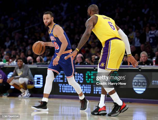 Stephen Curry of the Golden State Warriors dribbles in front of LeBron James of the Los Angeles Lakers during a 124-116 Lakers win at Crypto.com...