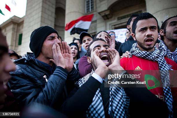 Students shout slogans in front of the Cairo University during a protest against the military rulers of the country on February 11, 2012 in Cairo,...