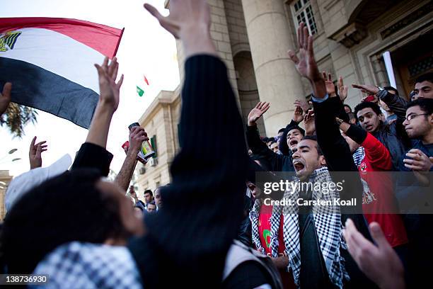 Students shout slogans in front of the Cairo University during a protest against the military rulers of the country on February 11, 2012 in Cairo,...