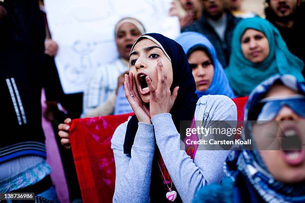 Female students shout slogans in front of the Cairo University during a protest against the military rulers of the country on February 11, 2012 in...