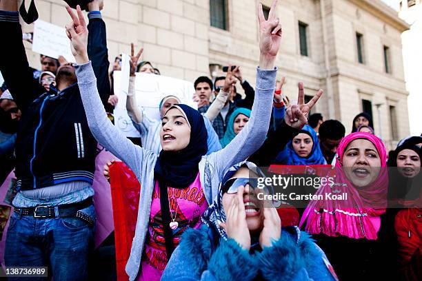 Female students shout slogans in front of the Cairo University during a protest against the military rulers of the country on February 11, 2012 in...