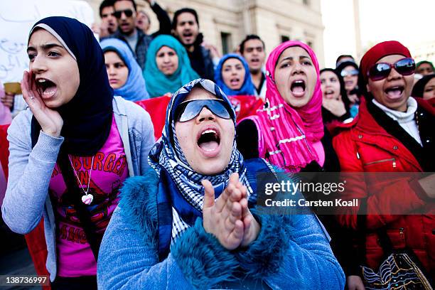 Female students shout slogans in front of the Cairo University during a protest against the military rulers of the country on February 11, 2012 in...