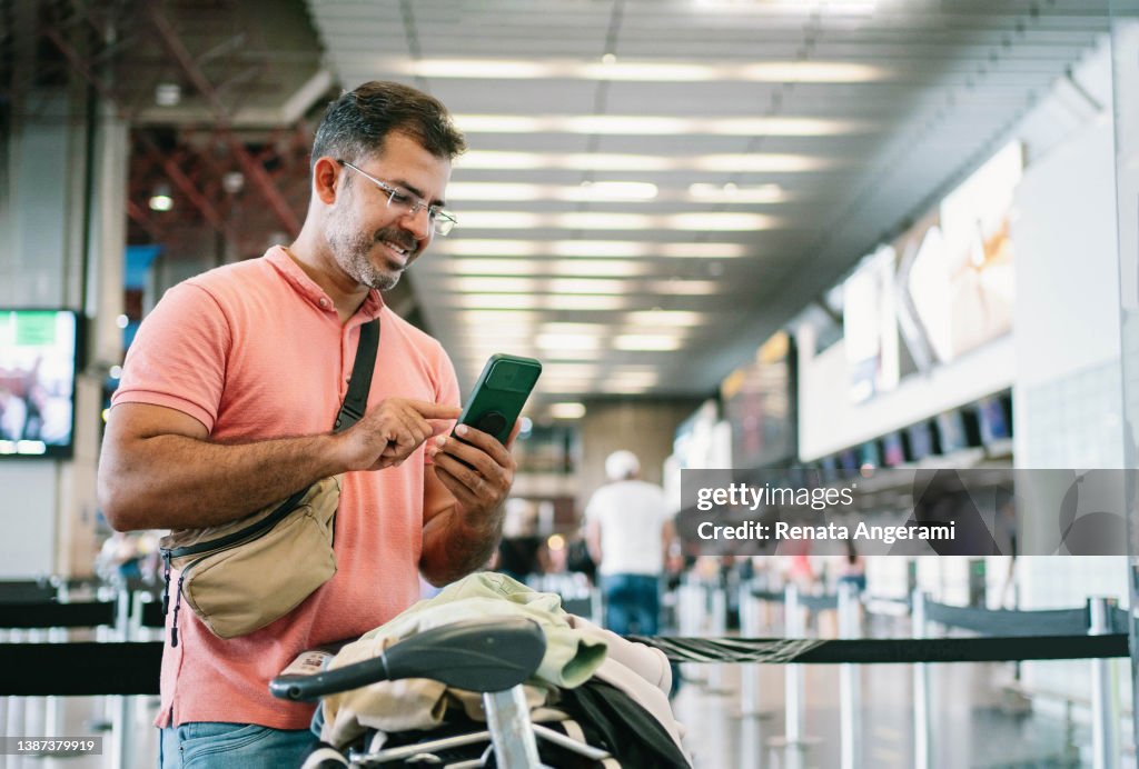 Mature man at airport waiting for check in