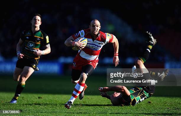 Charlie Sharples of Gloucester breaks past Andy Long of Northampton Saints to score a try during the Aviva Premiership match between Goucester and...