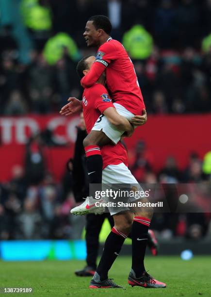 Patrice Evra of Manchester United celebrates victory with Rio Ferdinand after the Barclays Premier League match between Manchester United and...