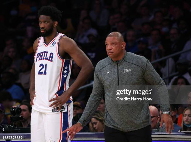 Joel Embiid and Doc Rivers watch play from the sidelines during the first half against the Los Angeles Lakers at Crypto.com Arena on March 23, 2022...