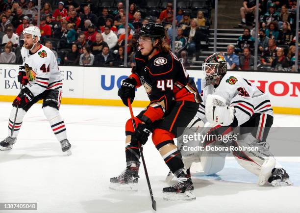 Max Comtois of the Anaheim Ducks battles for position against Kevin Lankinen of the Chicago Blackhawks during the game at Honda Center on March 23,...