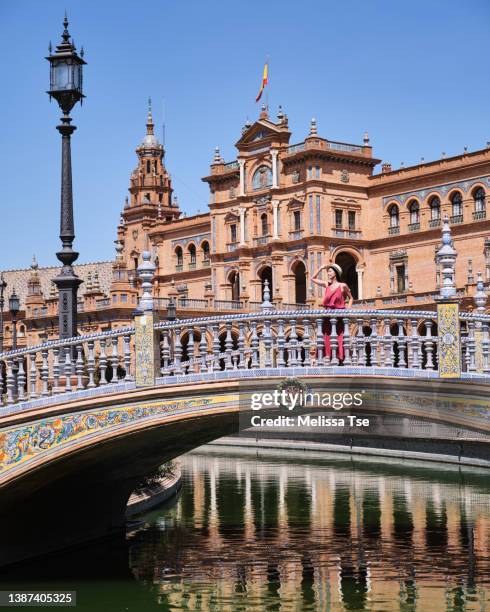 woman on bridge at plaza de espana in seville - seville tiles stock pictures, royalty-free photos & images