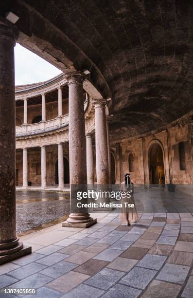 woman walking at the palace of charles v in the alhambra - alhambra granada stock-fotos und bilder