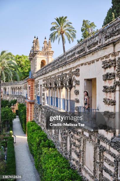 woman at royal alcazar gardens in seville - alcanzar stock-fotos und bilder